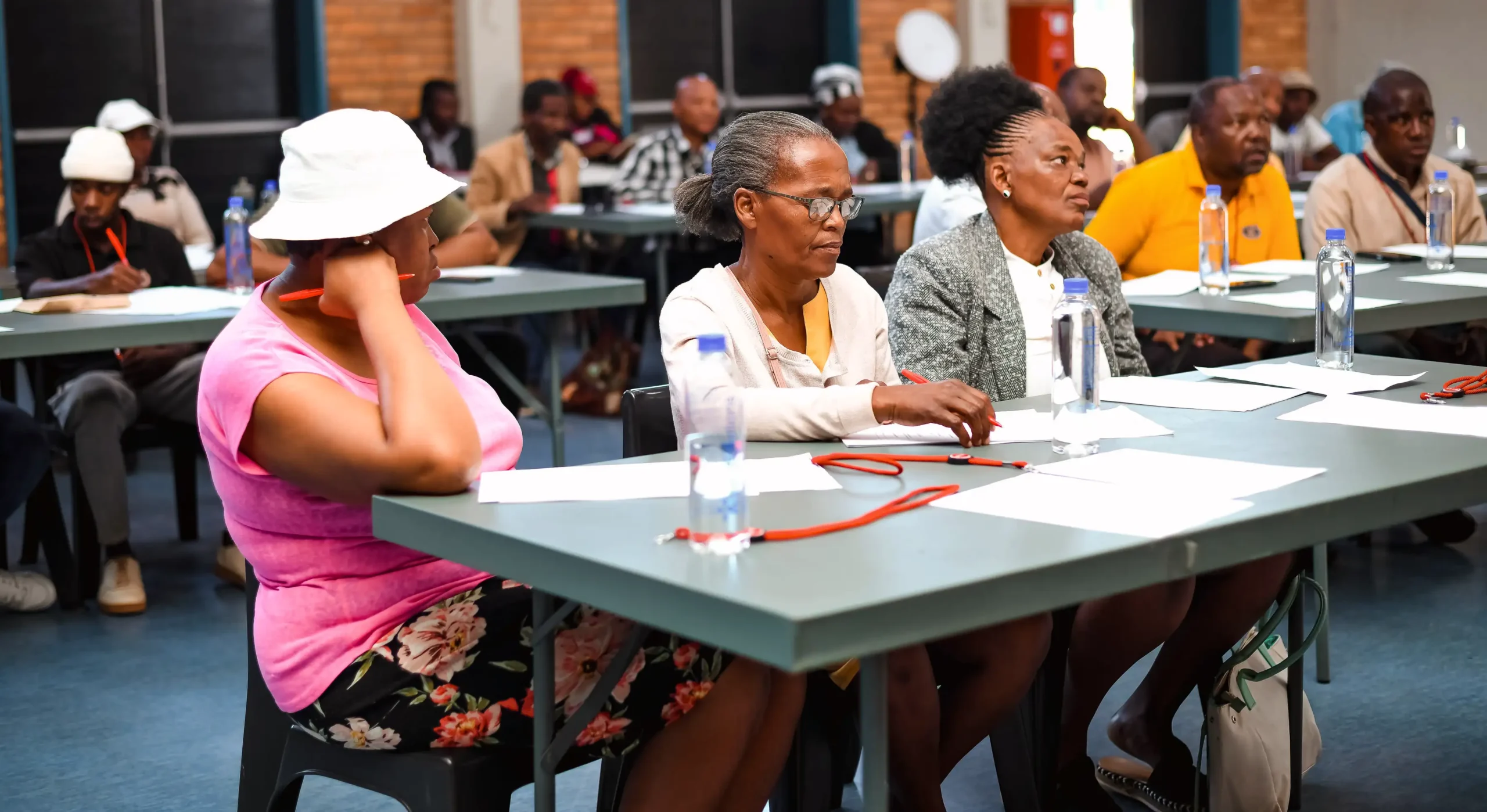 Community business owners attending a digital skills workshop in a large community hall